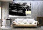 aranżacja fototapety z czarnym sportowym samochodem w pokoju za szarą sofą