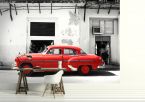 fototapeta z czerwonym samochodem przed białym budynkiem w nowoczesnym białym salonie