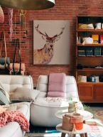 Canvas przedstawiający jelenia powieszony w salonie na ścianie z czerwonej cegły