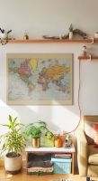 Obraz na płótnie przedstawiający mapę świata wiszący na białej ścianie od półką
