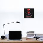Obraz Eye Patch z filmu Deadpool powieszony nad biurkiem z laptopem, książkami i czarną lampką