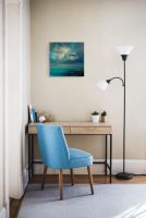 Obraz na płótnie z pejzażem w niebieskich barwach powieszony nad biurkiem w pokoju