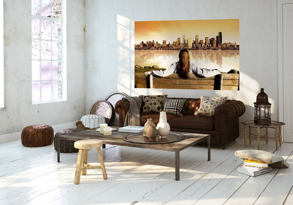 aranżacja fototapety z kobietą siedzącą na ławce i spoglądającą na panoramę miasta o zachodzie słońca w białym salonie nad beżową sofą