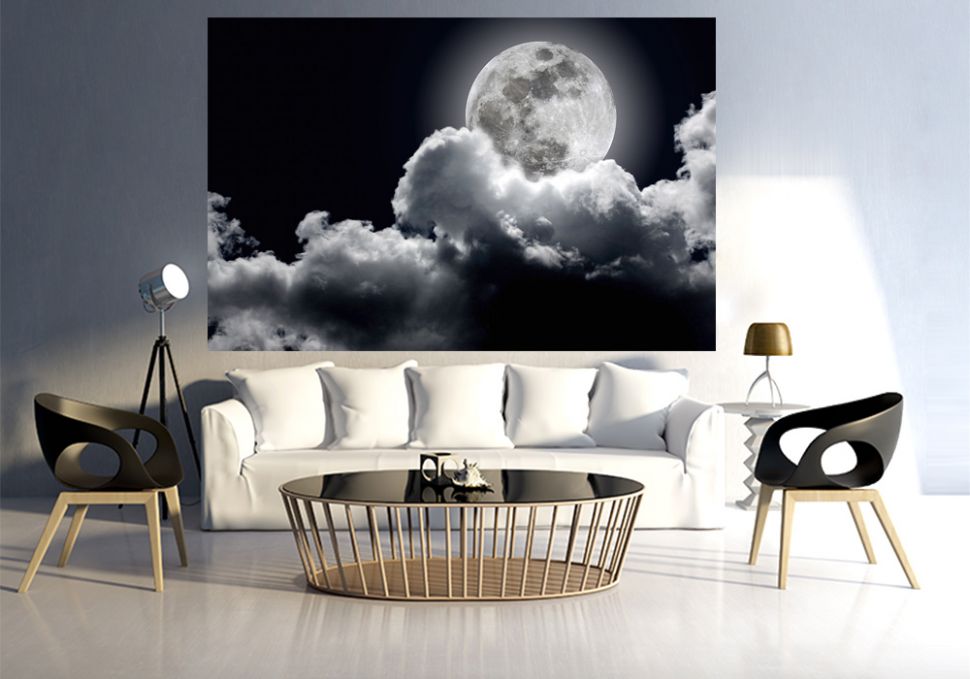 Fototapeta z zachmurzonym księżycem w mieszkaniu na ścianie nad białą kanapą