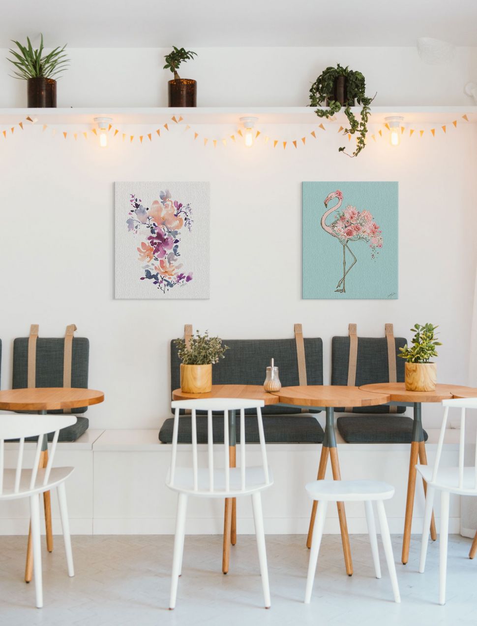 Obraz na płótnie z kwiatami powieszony na białej ścianie w kawiarni