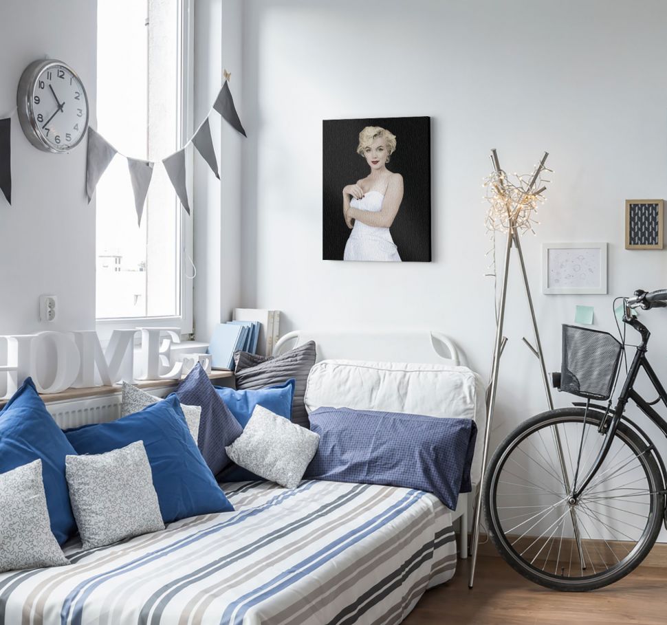 Obraz na płótnie z Marylin Monroe powieszony w jasnym stylowym pokoju na białej ścianie nad łóżkiem