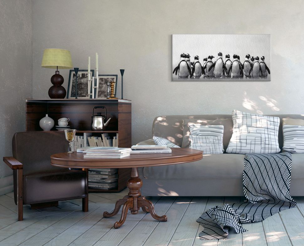 Canvas na plótnie zatytułowany Stado Pingwinów wykonany przez Marinę Cano powieszony w salonie nad szarą kanapą