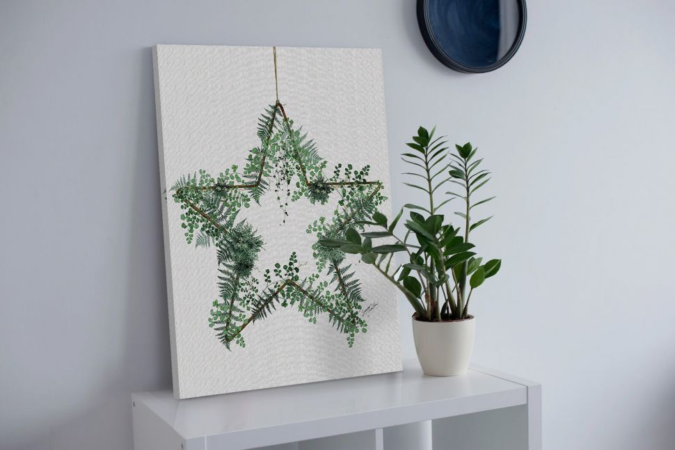 Canvas przedstawiający gwiazdę w liściach postawiony na białej półce